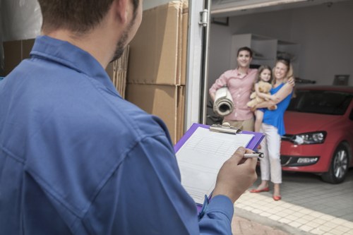 House removalists handling furniture in a Harmondsworth home