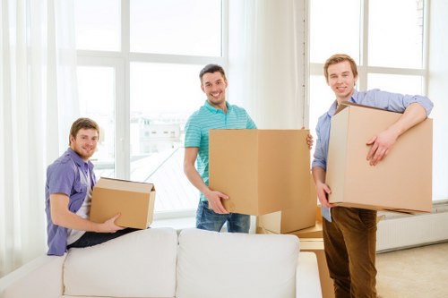 Packed moving boxes and furniture ready for collection in Harmondsworth