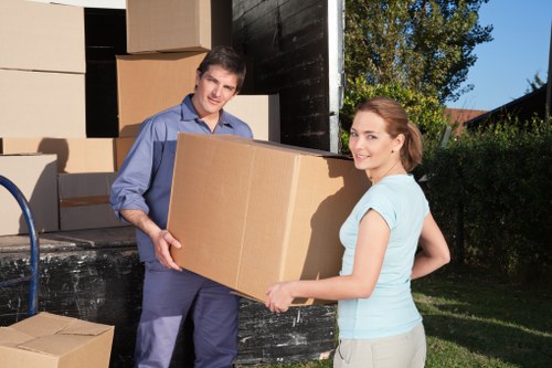 Removal team unloading boxes and furniture at a Harmondsworth property